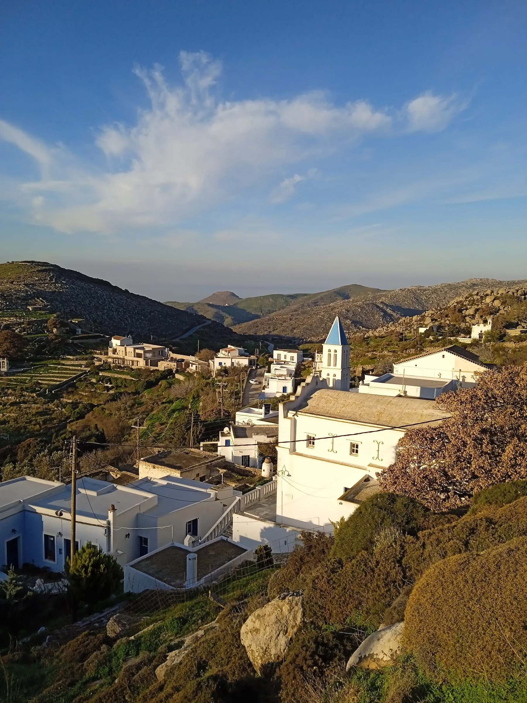 Το καμπαναριό και οι στέγες στο σούρουπο